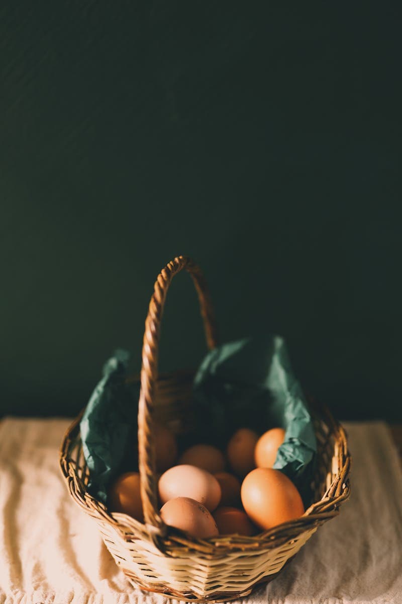 Wicker basket filled with rich brown eggs, similar to the dark brown eggs Barnevelder chickens produce