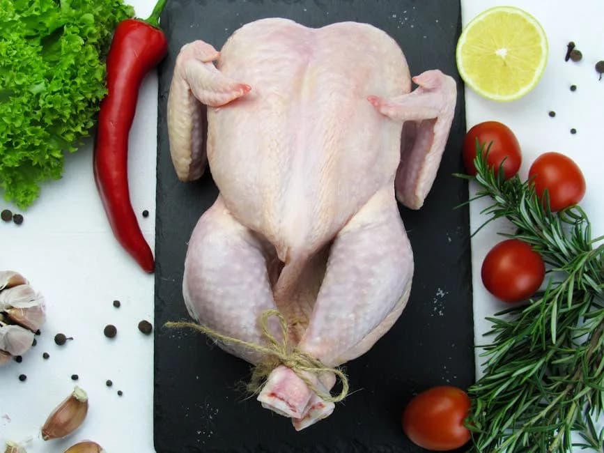 A whole raw chicken ready for cooking